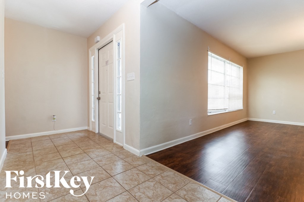 A room with a wooden floor and a white door.
