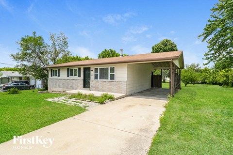A house with a brown roof and a garage door is for sale.