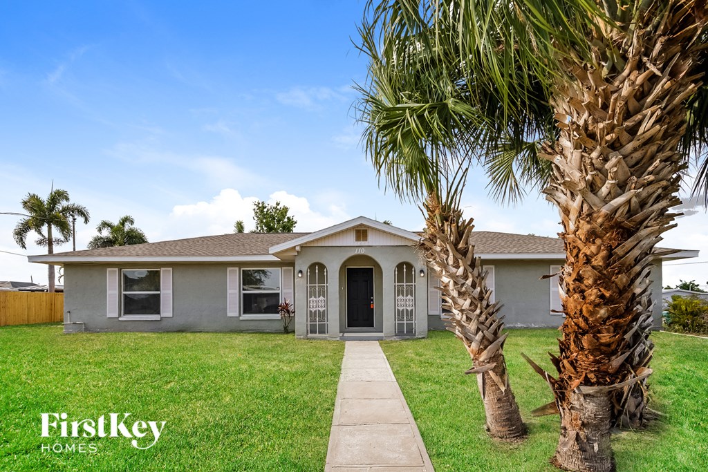 a house with palm trees in front of it