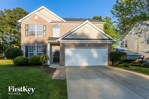 a home with a white garage door in front of it