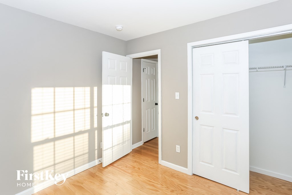 a bedroom with two closets and a door to a closet