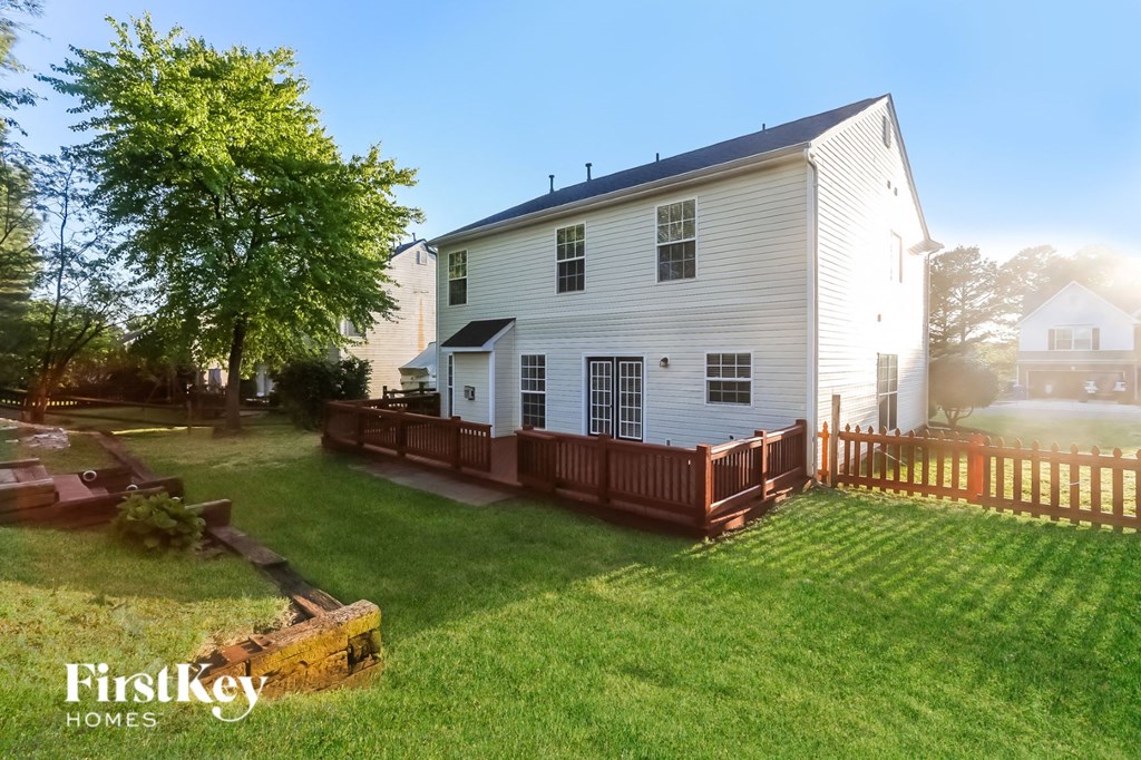 a white house with a wooden fence in front of it