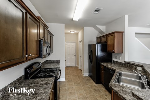 a kitchen with black appliances and granite counter tops