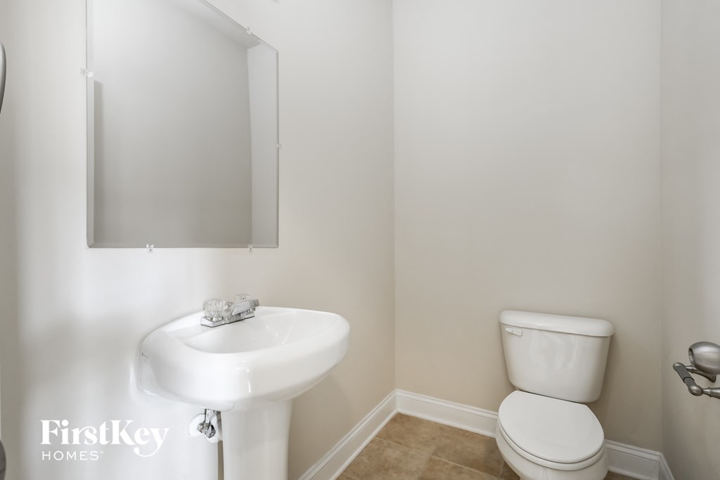 a small bathroom with a sink toilet and a mirror