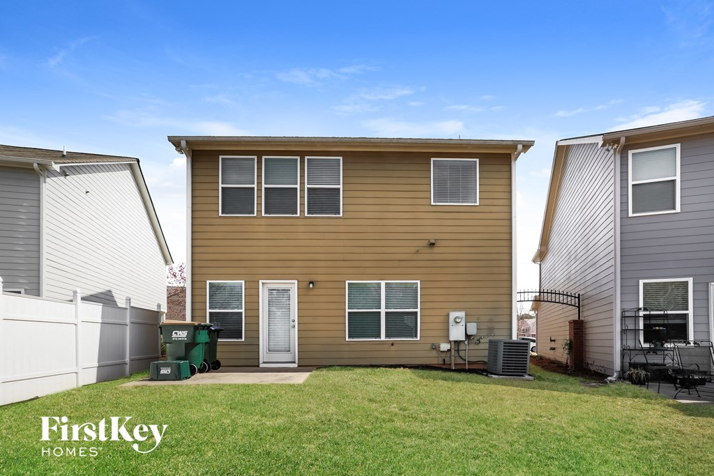 a yellow house with a yard in front of it