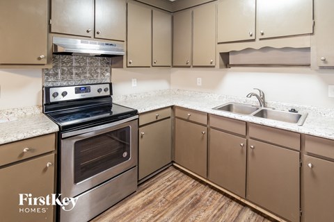 a kitchen with granite counter tops and stainless steel appliances
