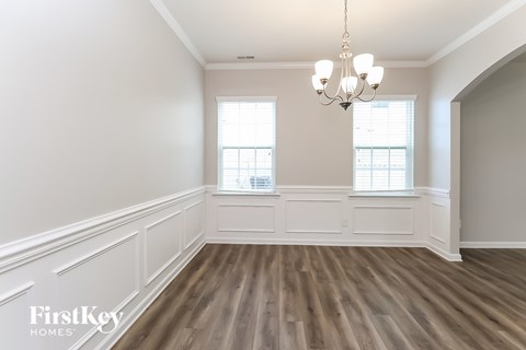 A room with wooden floors and a chandelier.