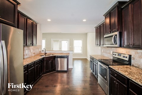 a kitchen with wooden cabinets and stainless steel appliances