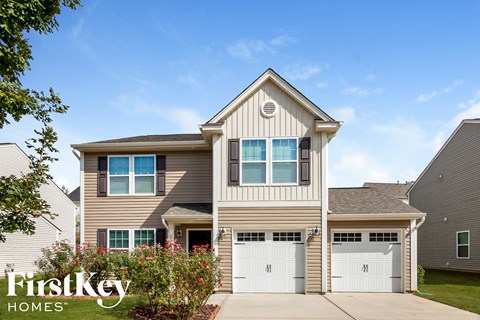 A two-story house with a garage is branded with the FirstKey Homes logo.