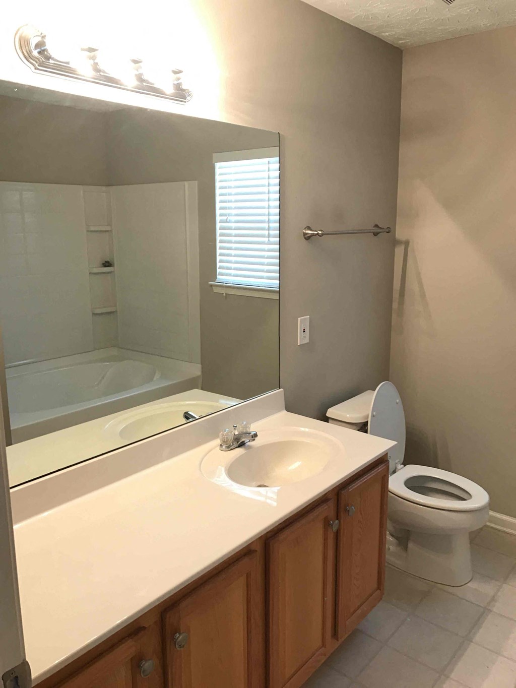 a bathroom with a sink toilet and a mirror