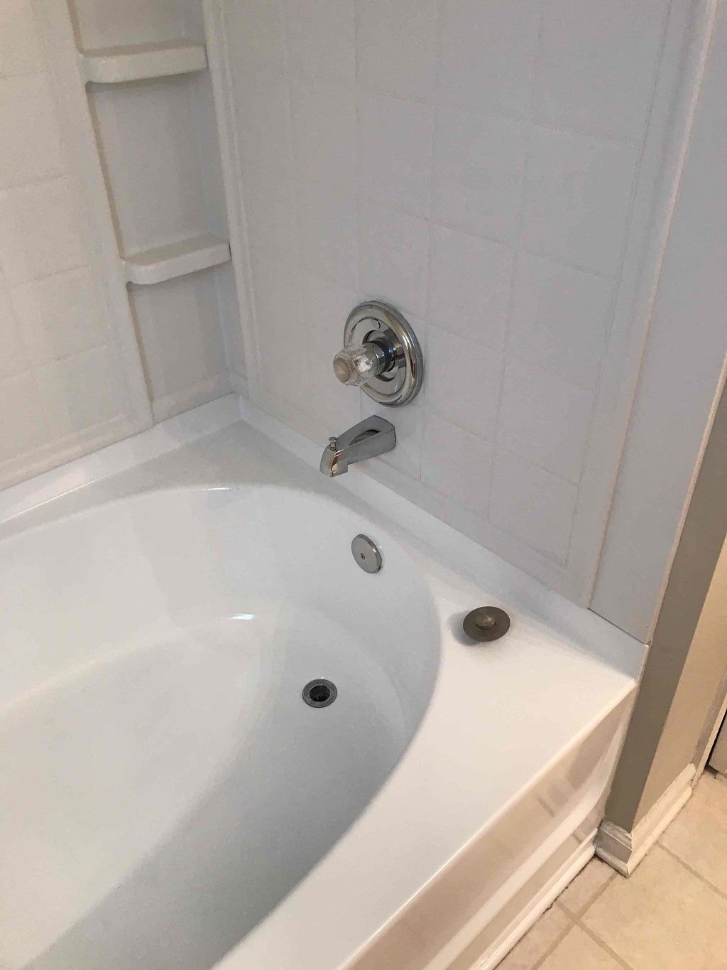 a white bath tub in a bathroom with a sink