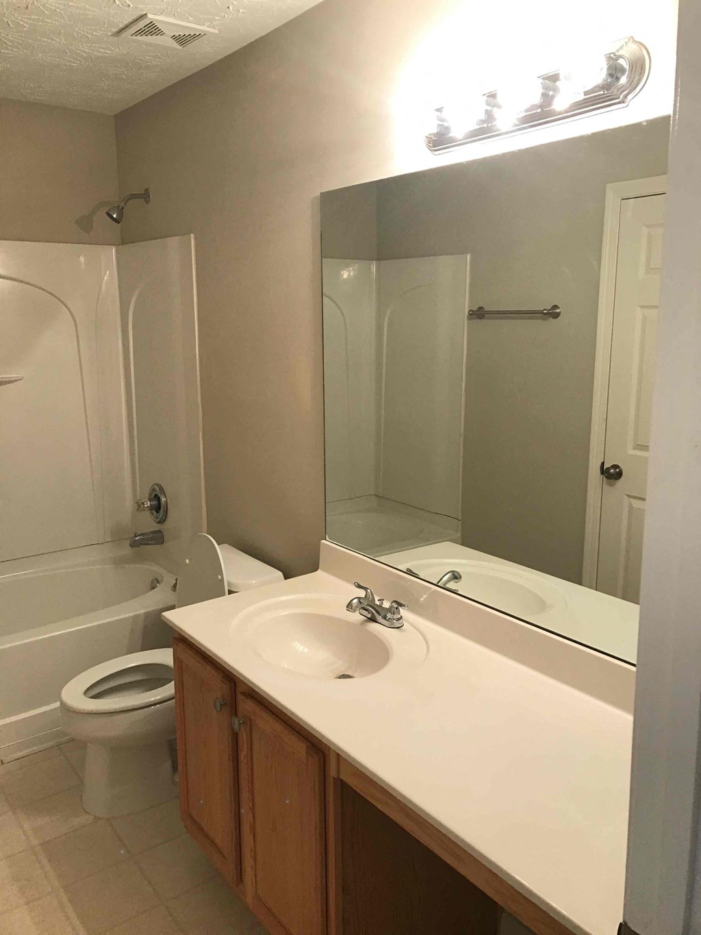 a bathroom with a sink and a toilet and a mirror