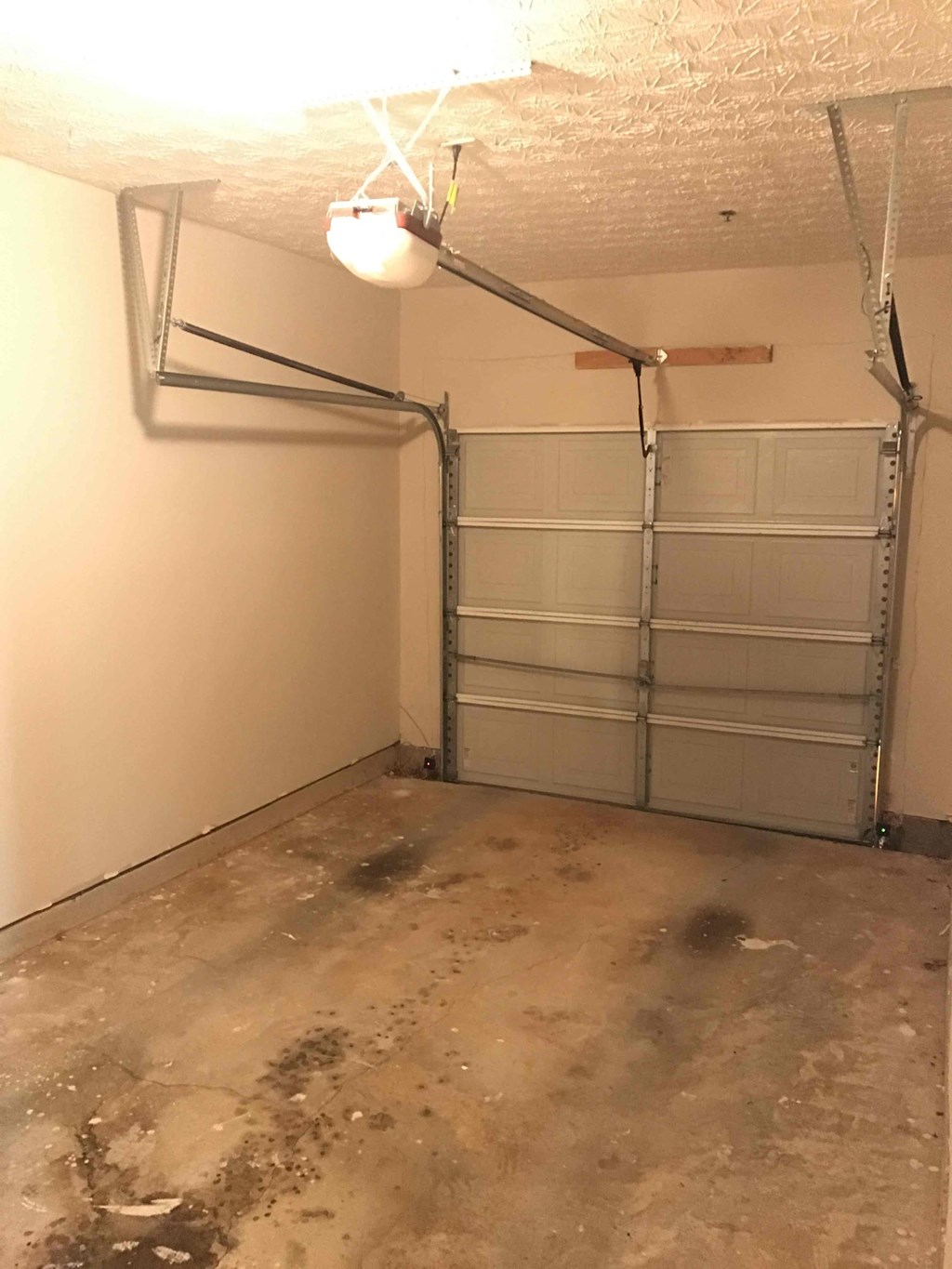 an empty garage with white walls and a white garage door