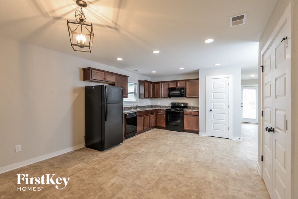 a kitchen with black appliances and brown cabinets