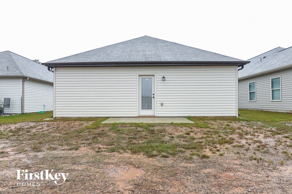 a small white house with a yard in front of it