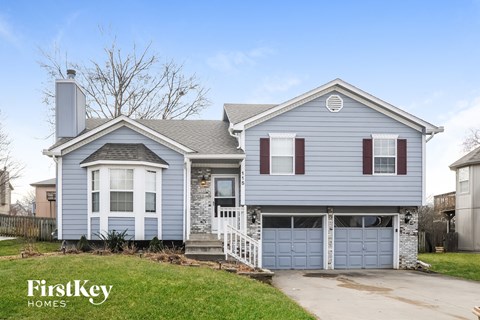 a blue house with a blue garage door