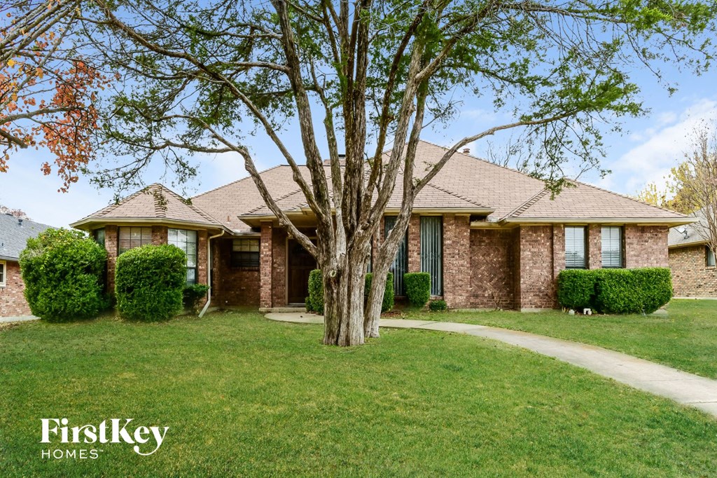 A house with a tree in front of it.