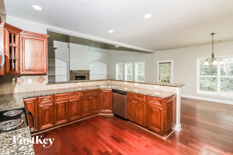 a kitchen with wooden cabinets and granite counter tops