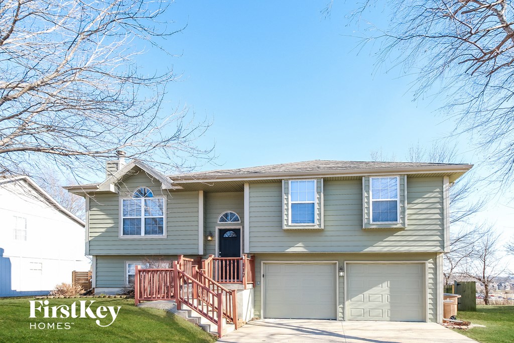 a house with a front porch and a blue sky
