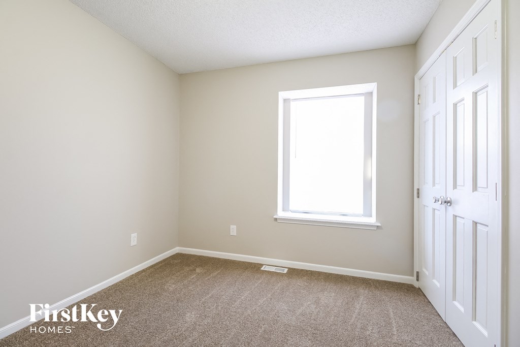 a empty room with a window and a door