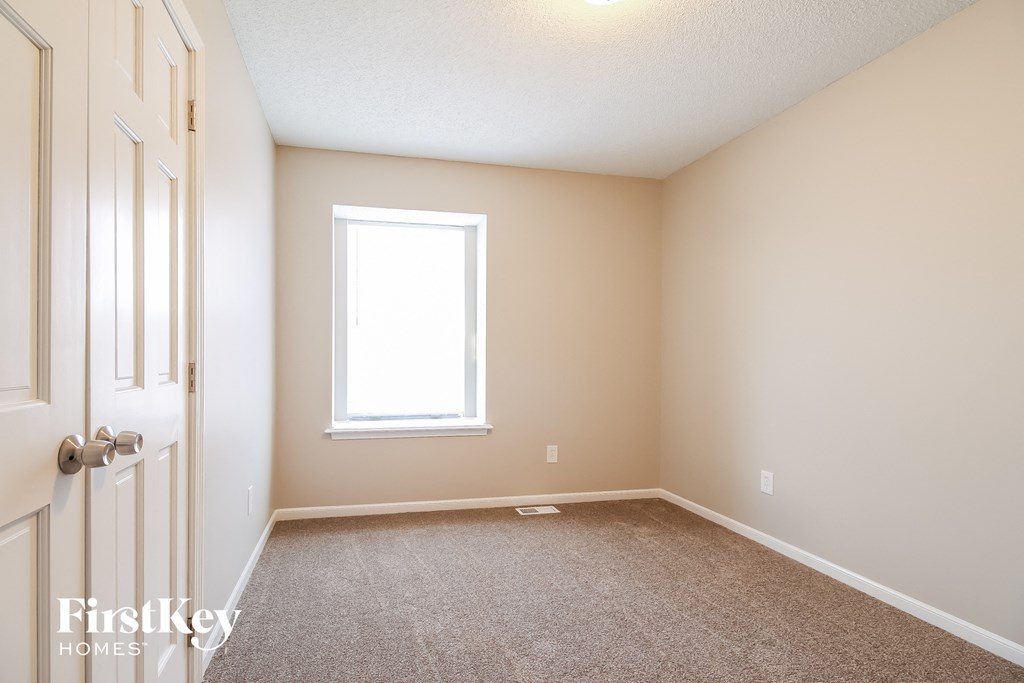 a empty room with a door and a window