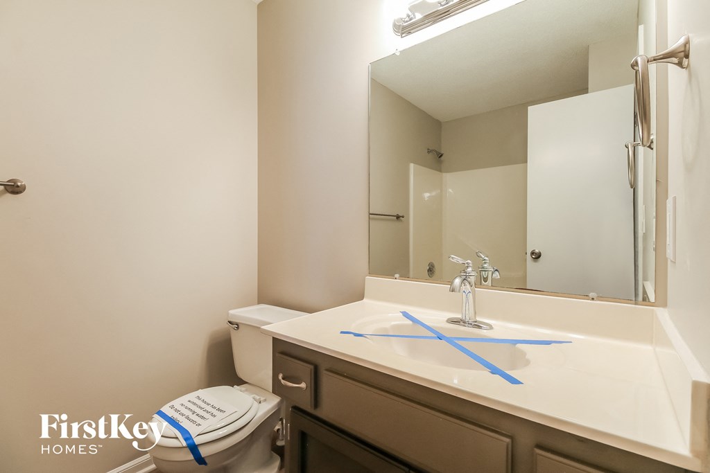 a bathroom with a sink and a mirror and a toilet