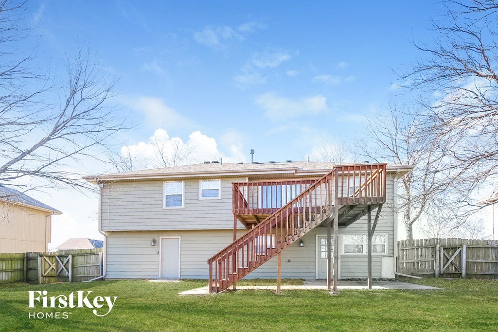 the exterior of a home with a deck and a staircase