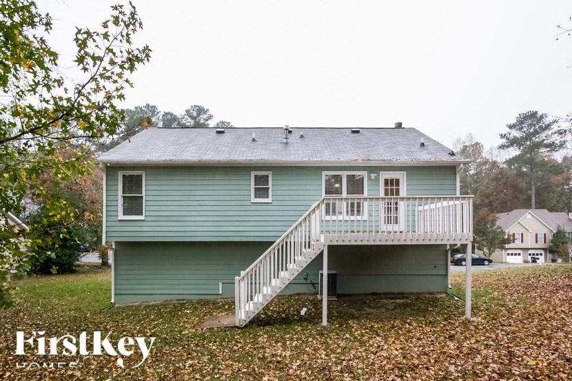 a blue house with a porch and a white deck