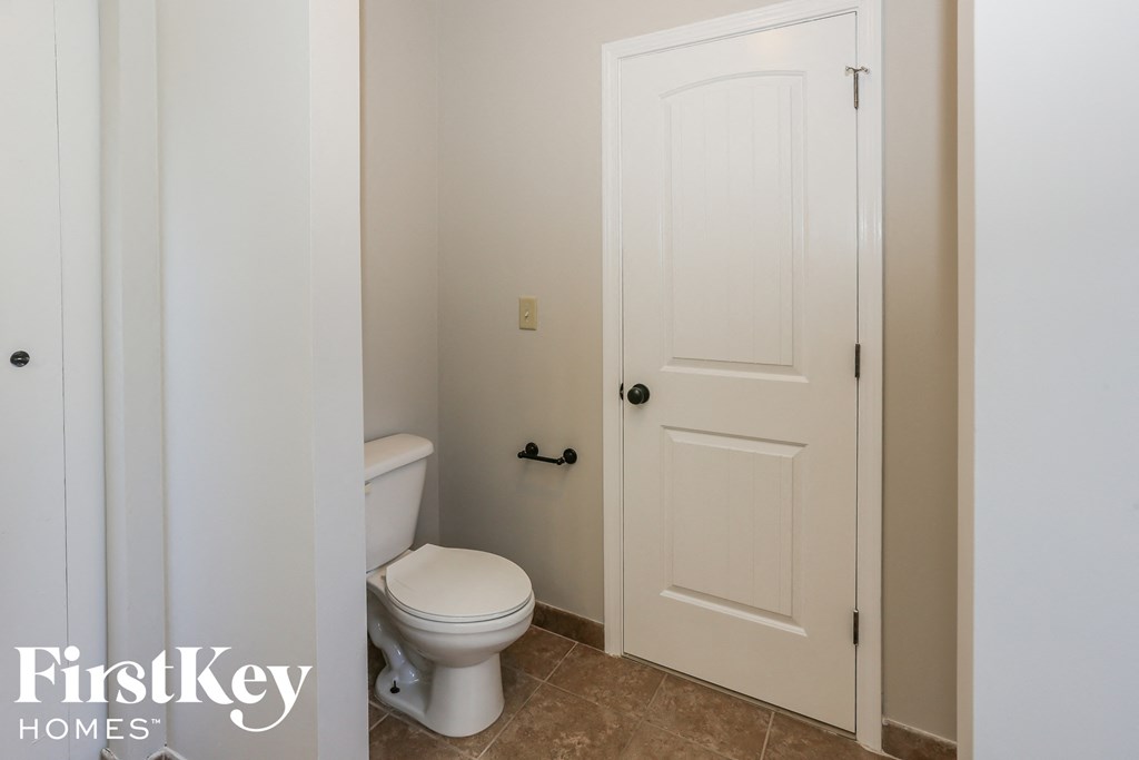 a small bathroom with a toilet and a white door
