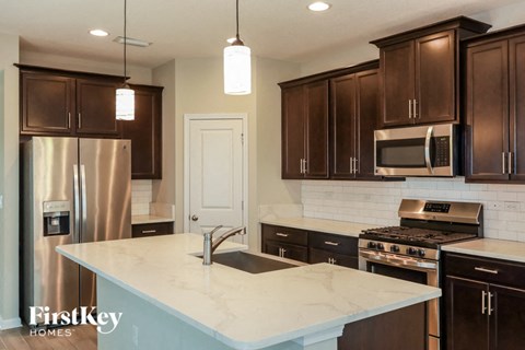 a kitchen with brown cabinets and a white counter top