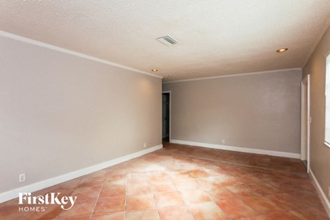 A room with a tile floor and a door on the left side.
