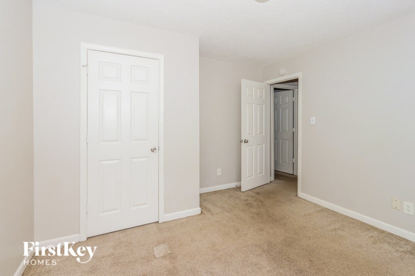a bedroom with two closets and a door to a hallway