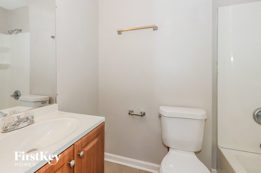 a bathroom with a toilet and a sink and a shower