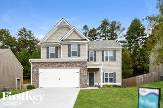 a house with a white garage door in front of a lawn