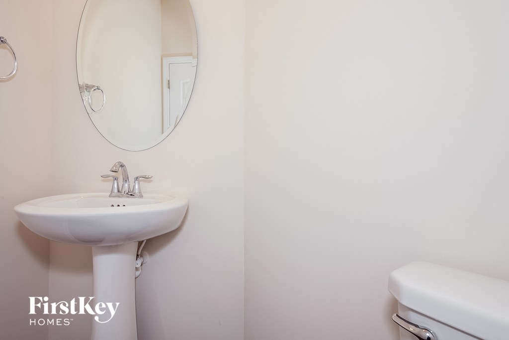 a bathroom with a sink and a mirror and a toilet