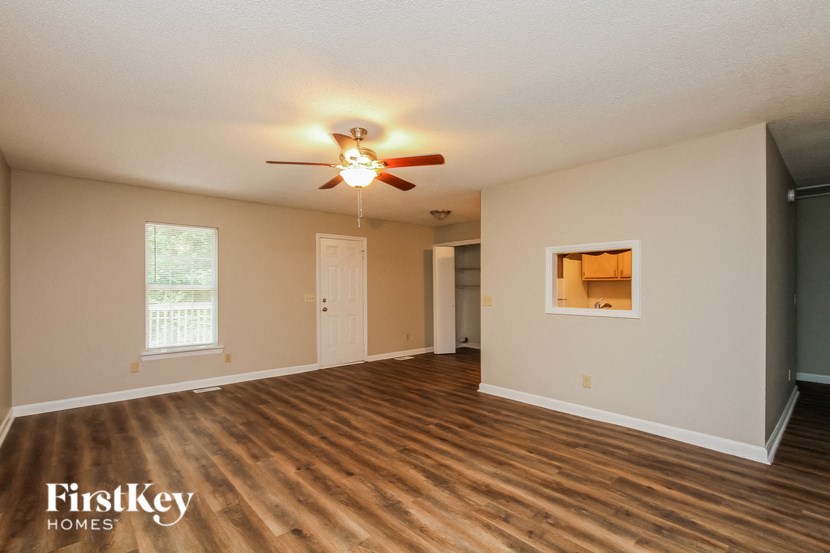 A room with wooden floors and a ceiling fan.