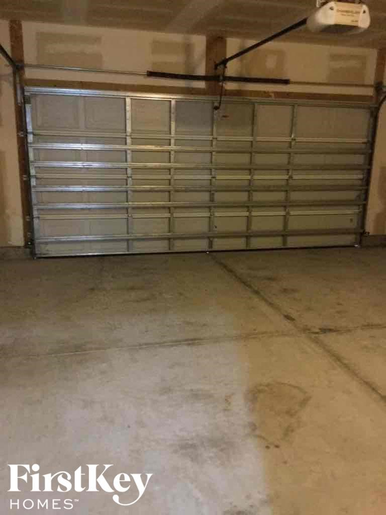 A garage door with a FirstKey Homes logo on the bottom.