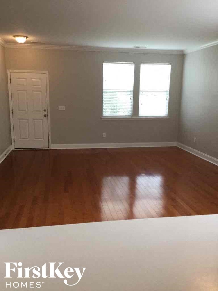A room with wooden floors and a white door.