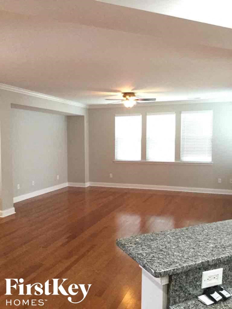 A room with wooden floors and a ceiling fan.