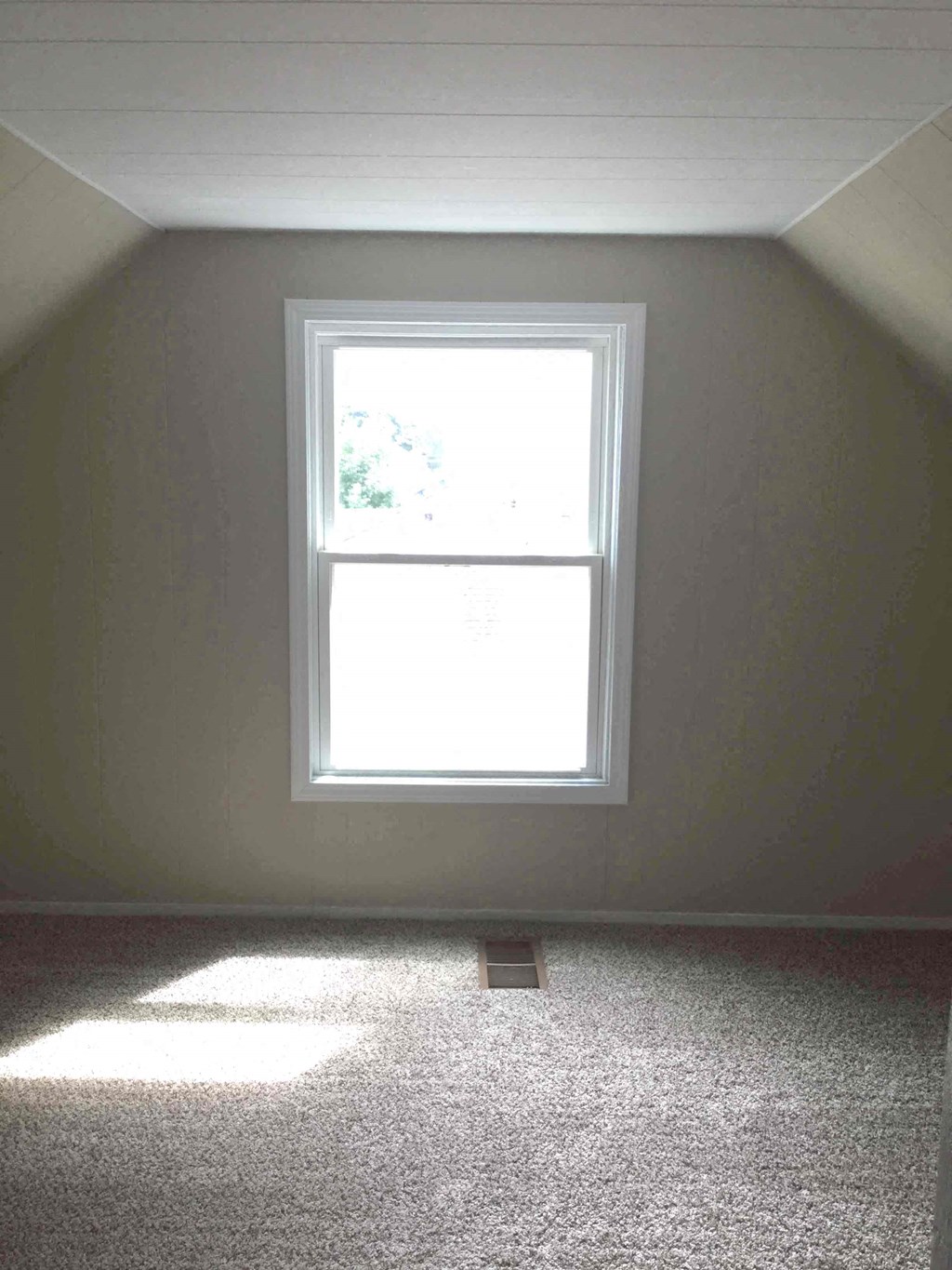 A window in a room with light coming through.