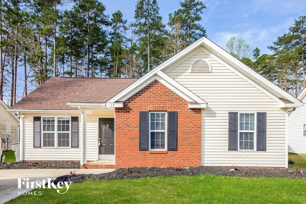 the front view of a white house with black shutters
