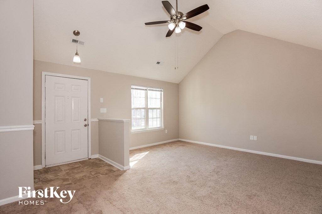 the master bedroom is spacious and has a closet and a ceiling fan
