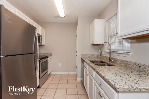 a kitchen with granite counter tops and stainless steel appliances