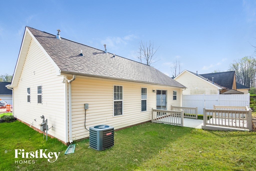 a white house with a white deck and a white fence