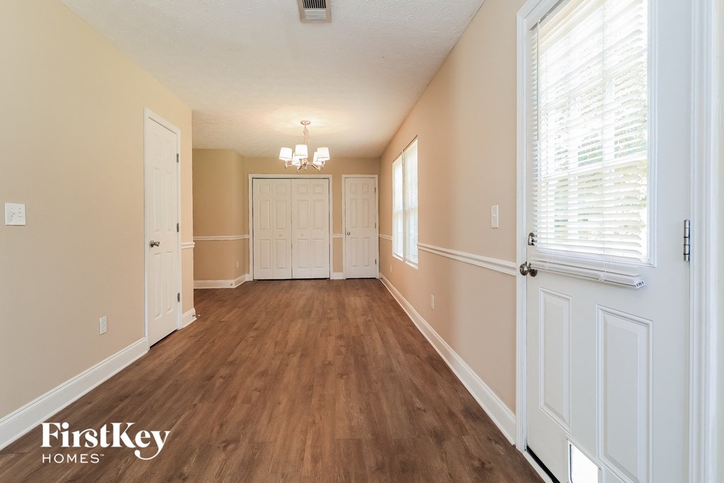 the living room and dining room of an empty house