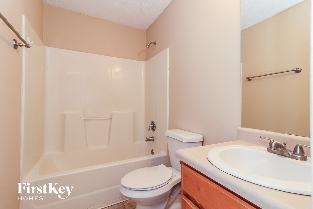 a bathroom with a sink toilet and a tub