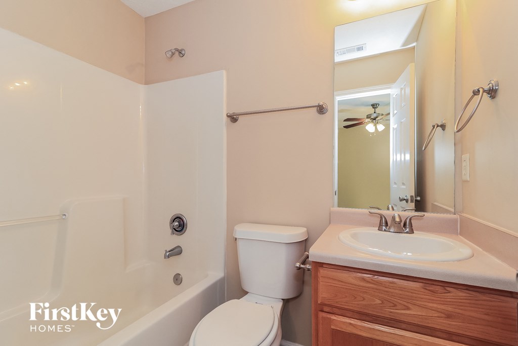 a bathroom with a sink toilet and a tub