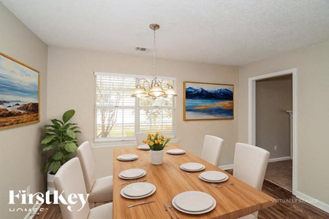 A dining room with a wooden table set for six.