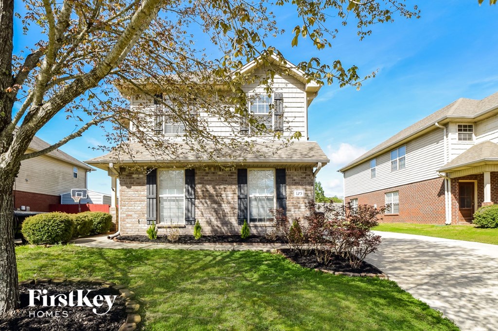 A house with a tree in front of it.