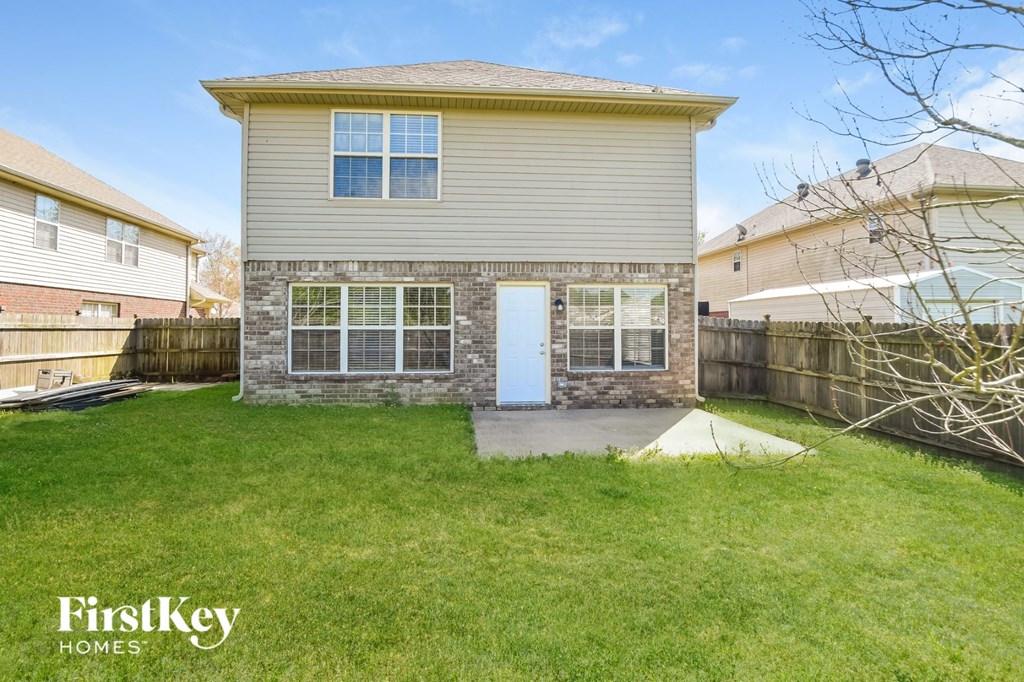 A house with a white door and a small front yard.